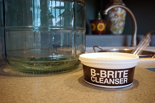 Cleaner for cider making equipment preparation b-brite cleaner for cider making in front of a glass carboy