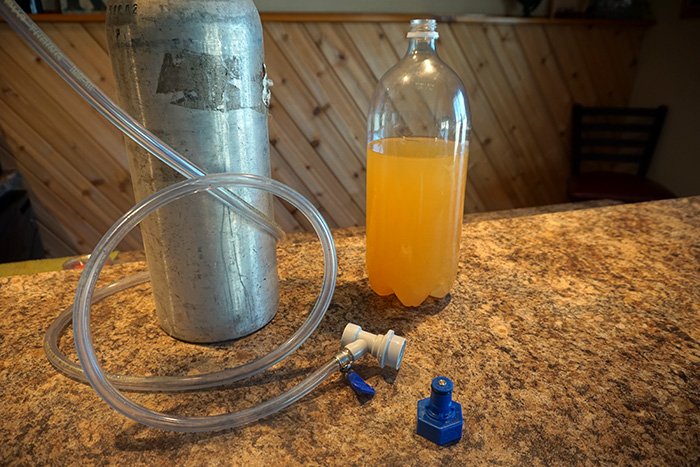 co2 tank connected to a carbonator cap for carbonating cider