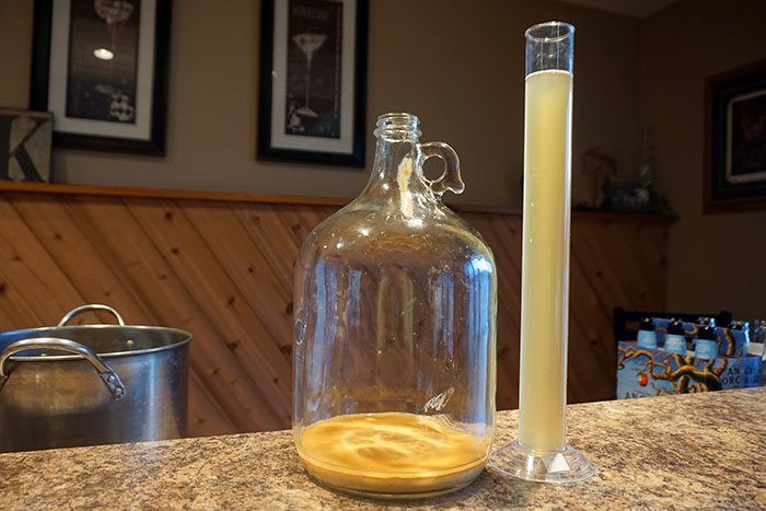 yeast lees on the bottom of a fermenter after racking cider