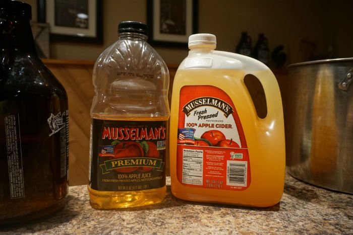 Museselmans cider for making hard cider two bottles of apple cider sitting on a table top
