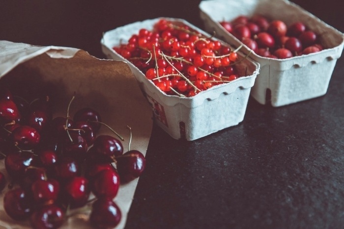 Three baskets of fresh red cherries